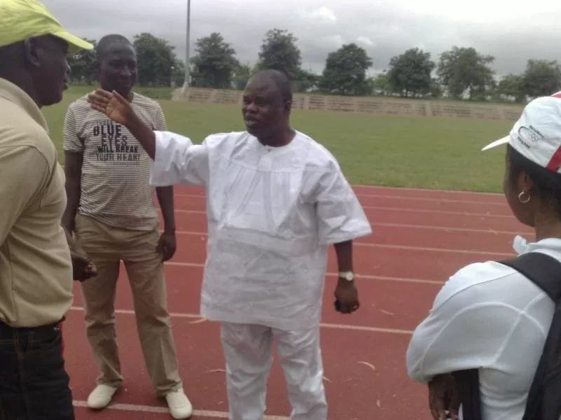 Ogba explains his point to his coaches and athletes